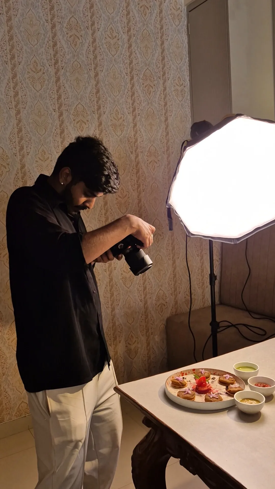 Sahil photographing a plated dish under an octagonal softbox during a food shoot